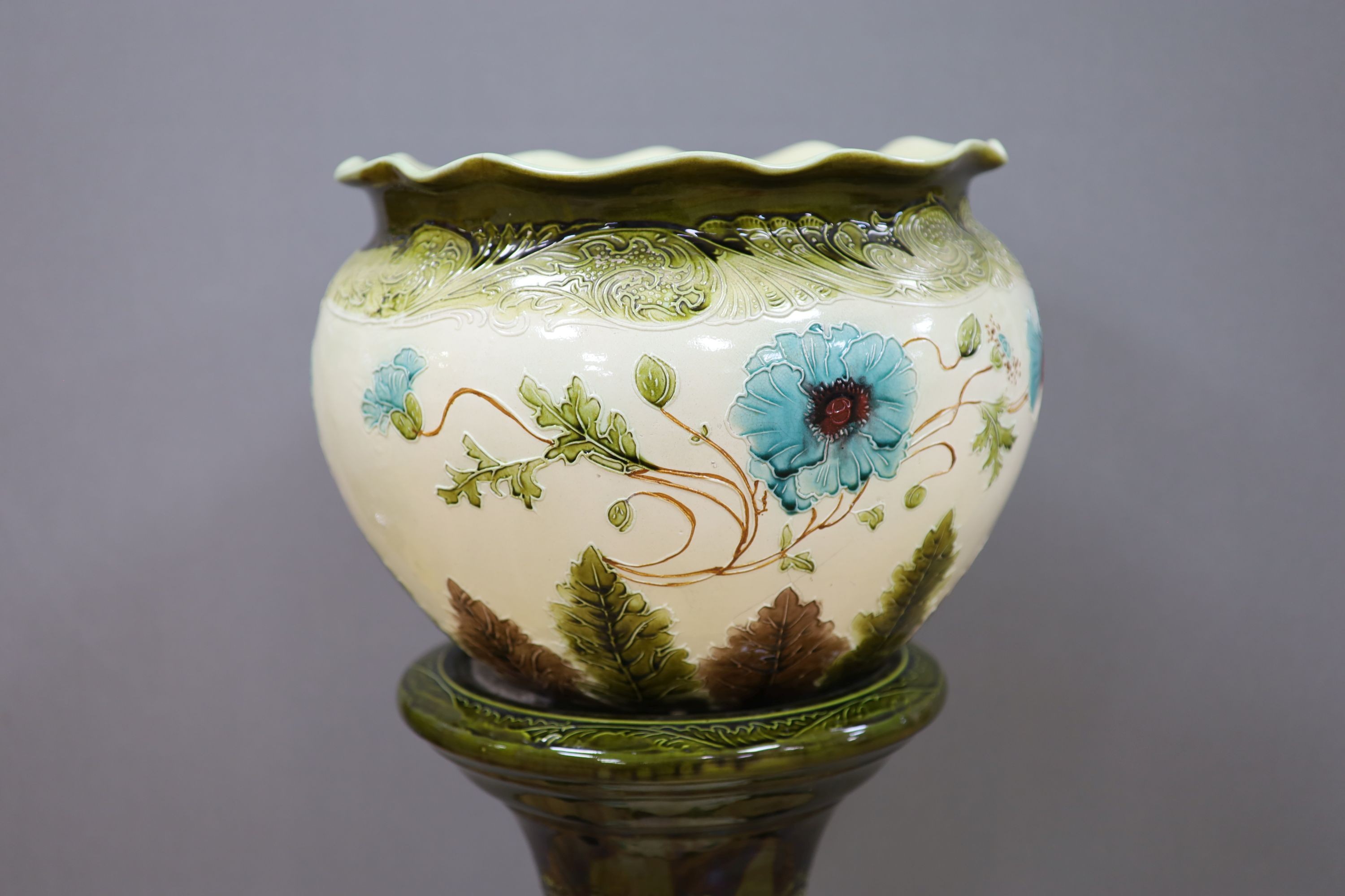 A Burmantofts style 'poppy' jardiniere and stand, total height 96 cm